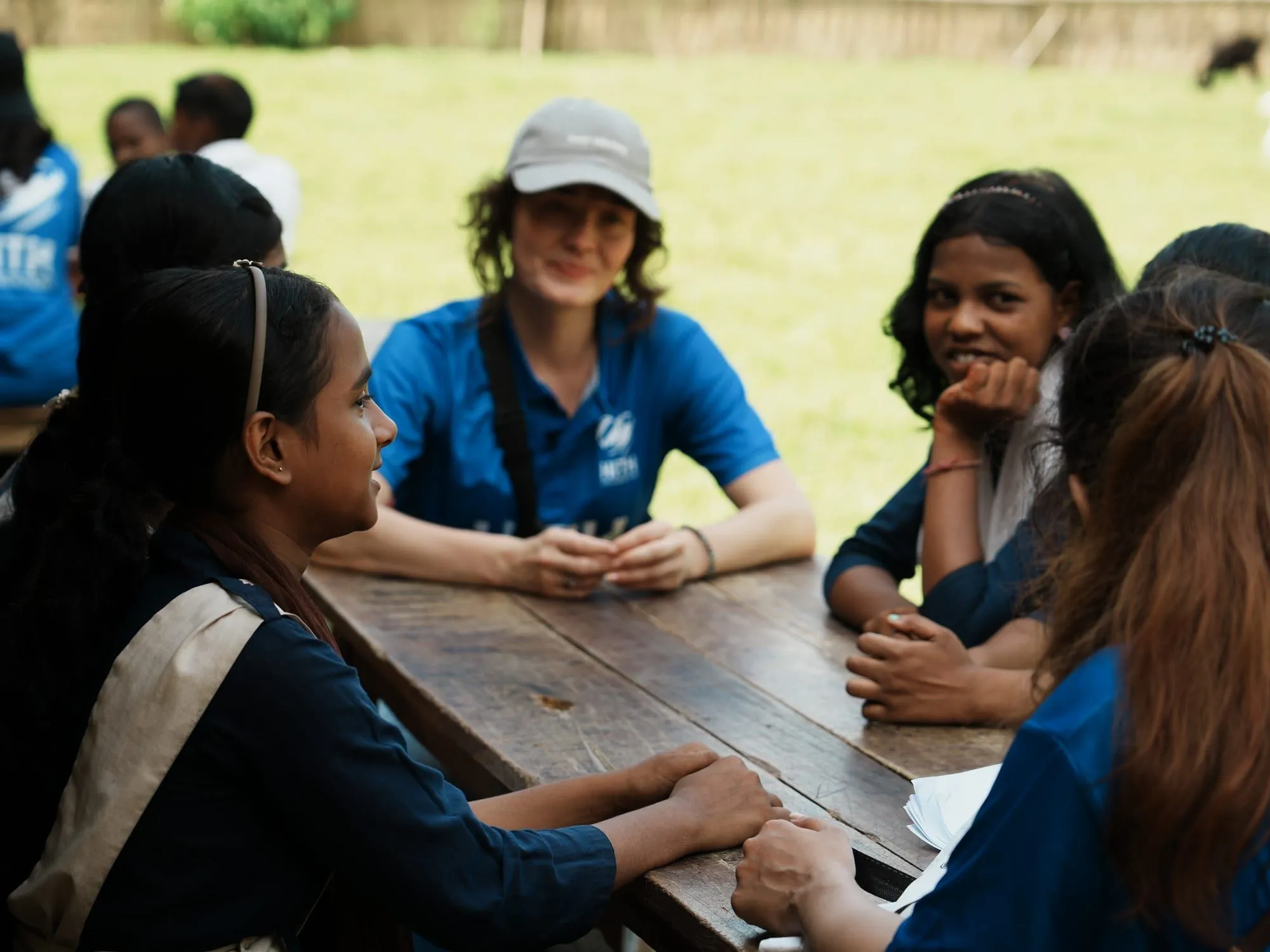 A HITH volunteer in conversation with schoolgirls of the tea garden community