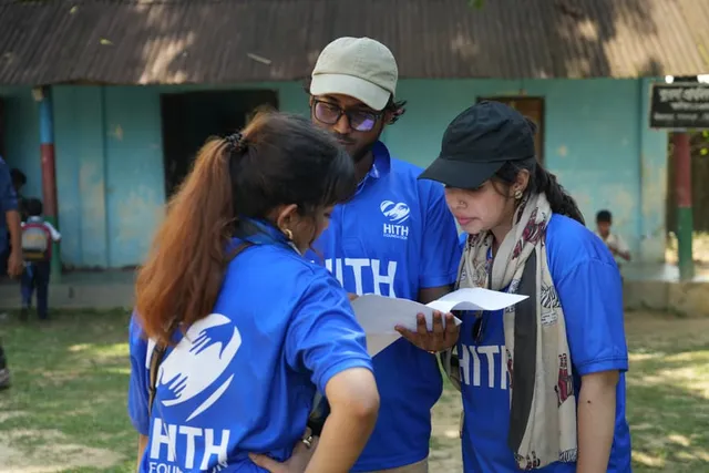 HITH volunteers coordinating over paperwork at the school
